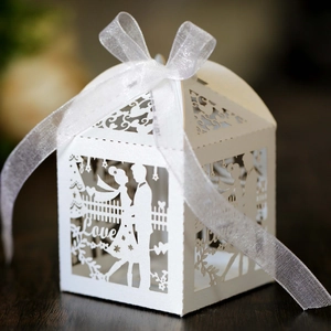 Detailed laser-cut white wedding candy box featuring a bride, groom, and Love motif