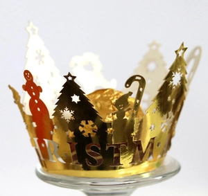 Detailed view of golden laser-cut Christmas crown wrapper with tree and snowman patterns