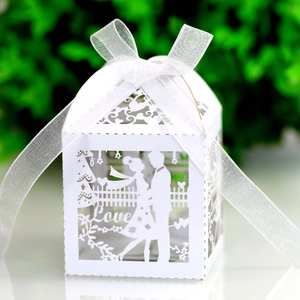 Detailed laser-cut white hollow wedding candy box with Love motif and ribbon bow