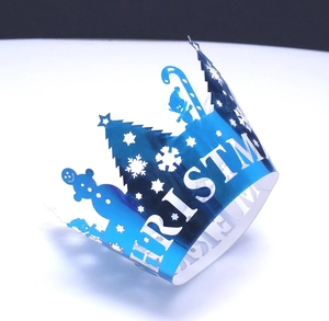 Laser-cut metallic blue Christmas crown wrapper with snowflake and tree cutout details
