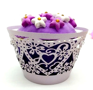 Purple cupcake wrapper with laser-cut heart patterns and star decorations