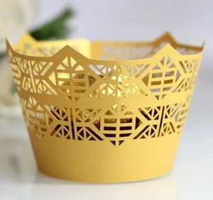 Elegant gold laser-cut cupcake wrappers with geometric crown design for party decor