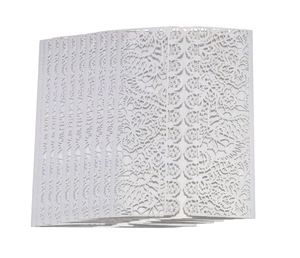 Detailed close-up of laser-cut white lace floral patterns on wedding invitation cards