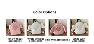 Detailed view of plush heart wings backpack in pink and white with decorative charms