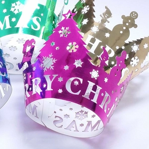 Macro shot of laser-cut Christmas party crowns with snowflake and tree patterns