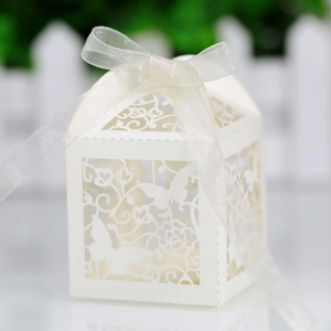Detailed laser-cut wedding candy box with elegant butterfly patterns and white ribbon