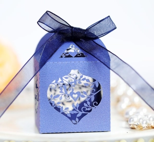 Detail of laser-cut heart and leaf pattern on a pearlescent purple wedding candy gift box