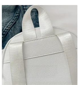 Detail of clean stitching on the back handle of the white PU leather backpack