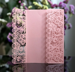 Pink laser-cut lace wedding invitation cover in shimmering pearlescent paper