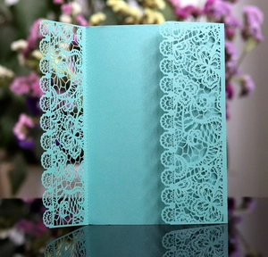 Laser cut lace wedding invitation in teal pearl paper with floral hollow out design