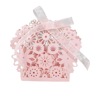 Pink laser-cut wedding favor box with floral patterns and silk ribbon closure