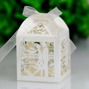 Laser-cut white wedding favor box featuring romantic couple silhouette and Love text