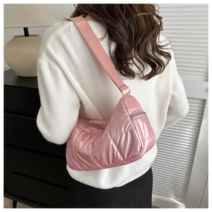 Detailed back view of a pink quilted crescent bag with adjustable strap and shiny finish