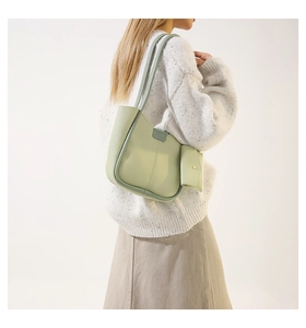 Minimalist bean green shoulder bag with matching coin pouch shown on a model