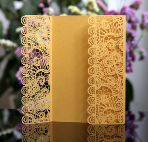 Detailed laser-cut floral lace pattern on elegant gold tri-fold wedding invitation card