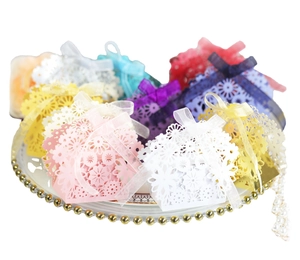 Laser-cut hollow paper favor boxes with ribbons for weddings and parties in various colors