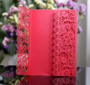Elegant red laser-cut wedding invitation card with intricate lace floral patterns