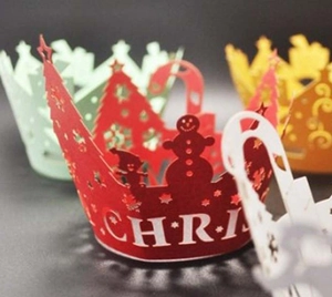 Macro detail of laser-cut silver Christmas tree cupcake wrappers for holiday parties