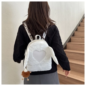 Detailed back view of white plush backpack featuring bunny ears and heart patch