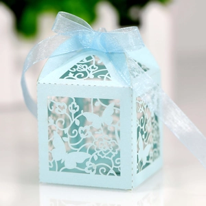 Macro shot of light blue laser-cut hollow candy box with pearl paper and silk ribbon