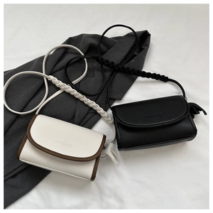 Close-up of vintage leather small square bags with woven straps on a blazer