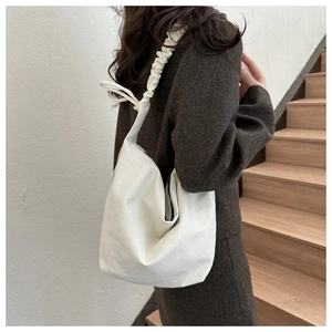 White canvas large capacity hobo bag featuring scrunchie strap and bow details