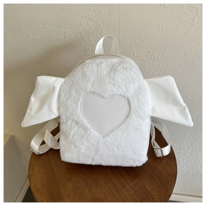 Detail of white plush backpack with fabric wings and leather heart patch