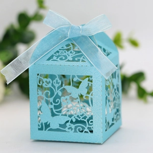 Detail view of laser-cut butterfly gift box in light blue pearl paper with ribbon bow