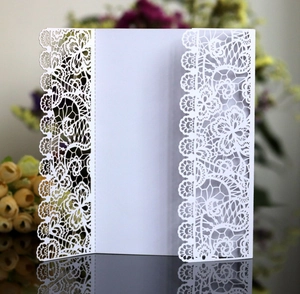 Elegant white laser-cut lace wedding invitation cover with intricate floral hollow pattern