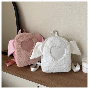 Detail of plush heart backpacks in pink and white with soft faux fur texture