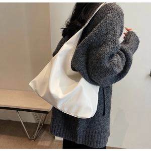 Detailed view of the white large hobo bag showing soft PU leather texture and stitching