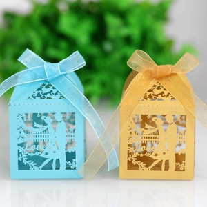 Laser-cut wedding favor boxes with Love heart silhouette and satin ribbons