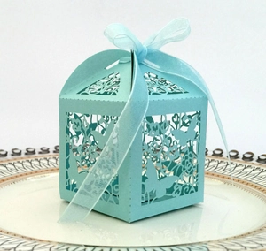 Detail of laser-cut butterfly and flower patterns on light blue wedding favor gift box
