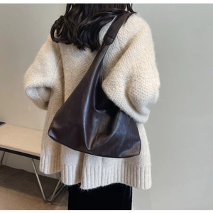Deep brown large capacity faux leather tote bag worn with a white knit sweater
