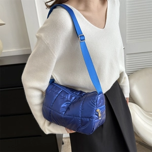 Quilted shiny blue puffer crossbody bag with adjustable strap and golden zipper