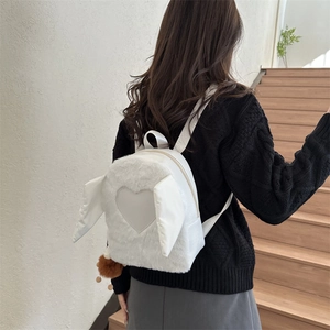 White faux fur backpack with heart applique and wing design for casual autumn fashion