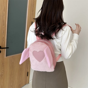 Pink plush backpack with cute bunny ears and heart patch shown on model back