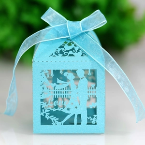 Detail of laser-cut wedding candy box in sky blue with LOVE lettering and silk ribbon