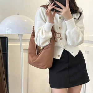 Brown canvas hobo bag with pleated shoulder strap and bow detail for daily casual wear