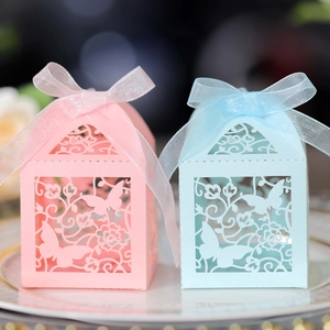 Detail of laser-cut butterfly gift boxes with ribbons in pink and blue pastel colors