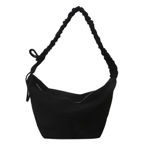 Minimalist black canvas hobo bag with pleated shoulder strap and side bow detail