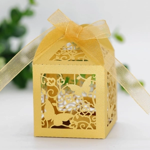 Detailed laser cut golden butterfly gift box with elegant organza ribbon and floral patterns