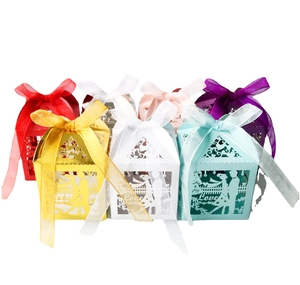 Detail of laser cut wedding candy boxes with Love text and ribbon in various colors
