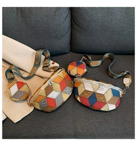 Detail of color-block waist bag with textured leather and embroidered guitar strap