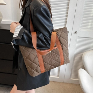 Quilted tote bag with brown diamond lattice pattern and vibrant orange shoulder straps