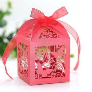 Detailed laser-cut butterfly hollow pattern on red paper candy box with chiffon ribbon