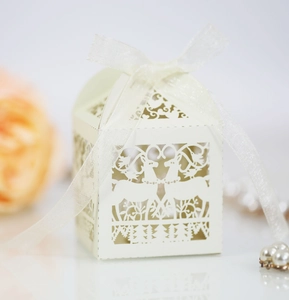 Laser-cut white gift box with reindeer patterns and white ribbon for holiday favors