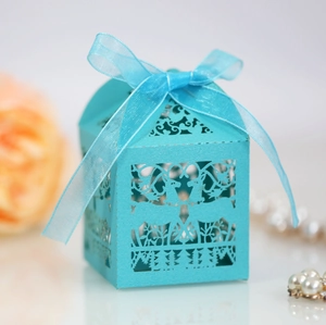 Detail of laser-cut light blue candy box featuring reindeer motif and ribbon bow
