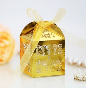 Macro detail of golden laser-cut reindeer gift box with elegant translucent ribbon tie