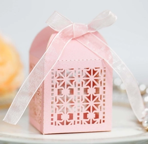 Elegant pink laser-cut wedding favor box with pearl paper texture and sheer ribbon bow